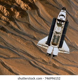 Space Shuttle orbiting Mars. Elements of this image furnished by NASA.