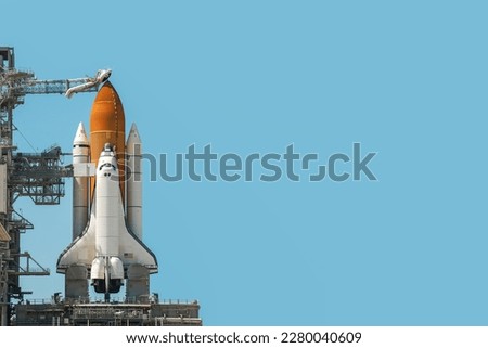 Space shuttle rocket isolated on blue cyan background with copy space. Elements of this image furnished by NASA.