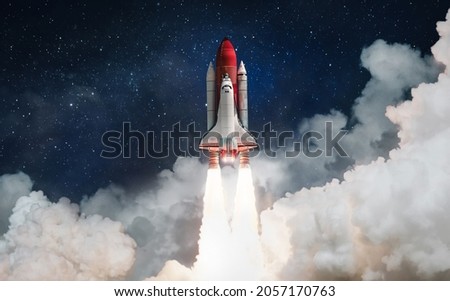 Space shuttle rocket launch in the clouds with stars to outer space. Space on background. Sky and clouds. Spaceship flight. Elements of this image furnished by NASA