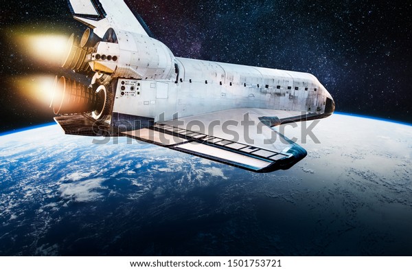 Space shuttle\
rocket in outer space over Earth planet. Ocean and clouds on\
surface. Sci-fi wallpaper. View from ISS. Cosmos background.\
Elements of this image furnished by\
NASA