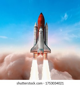 Space Shuttle Take Off From Earth In The Sky. Bright Clouds. Expedition To The ISS Station. Exploration Of Space And Science. Astronomy. Elements Of This Image Furnished By NASA