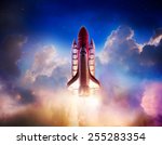 Space shuttle taking off on a mission / Photo composite of a repainted toy in a cloud background