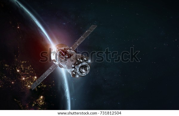 Space station and space ship in the outer space.\
Earth sunshine on the background. Elements of this image furnished\
by NASA