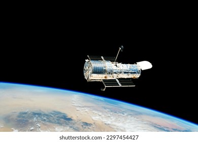 A space telescope in outer space. Elements of this image furnished NASA. High quality photo - Powered by Shutterstock