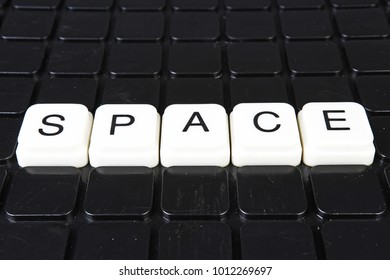 Space text word title caption label cover backdrop background. Alphabet letter toy blocks on black reflective background. White alphabetical letters. White educational toy block with words.