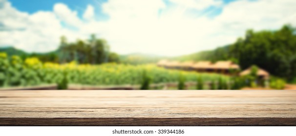 Space Of Wood Table Platform And Farm Of Field Background Vintage Tone.