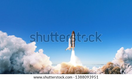 Spacecraft takes off into space. The rocket starts in the blue sky. Travel concept