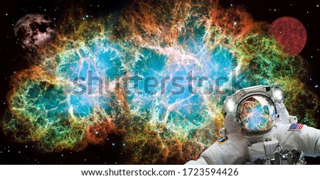 Spaceman astronaut in outer deep space people with Crab Nebula behind him. It is a supernova remnant, a stellar explosion. Solar system universe. Elements of this image furnished by NASA.