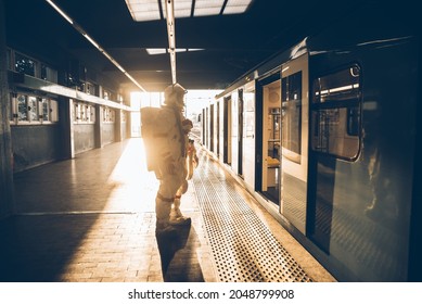 spaceman in a futuristic station. Man with space suit leaving for work and getting the train