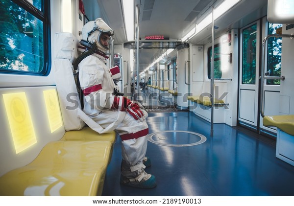 spaceman in a futuristic station. Man\
with space suit leaving for work and getting the\
train