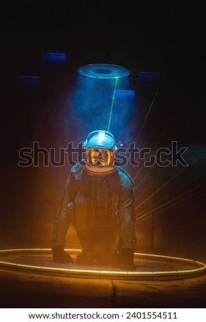 Spaceman or star trooper in the helmet in dark teleporting through the portal concept. Science fiction concept. Outer space travel.