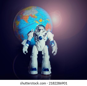 Spaceman Toy On The Background Of The Planet Earth In The Area Of Australia, India And China. Space Program Concept.