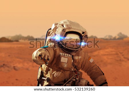 Spaceman walks on the red planet Mars. Space Mission. Astronaut travel in space