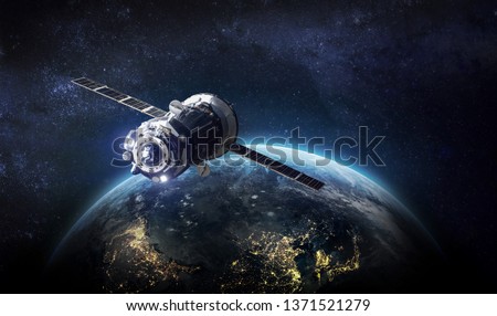 Spaceship and Earth on the background. Solar system. Elements of this image furnished by NASA