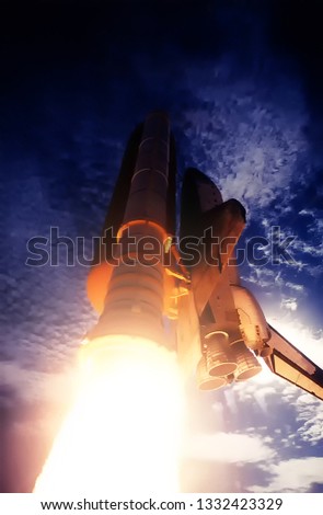 Spaceship launch in clouds. Rocket liftoff into space. The elements of this image furnished by NASA.