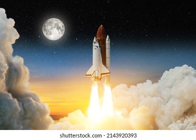 Spaceship lift off. Space shuttle with smoke and blast takes off into space on a background of a sunset with a full moon and stars in the sky. Elements of this image furnished by NASA.