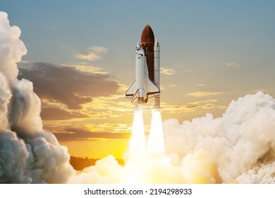 Spaceship lift off. Space shuttle with smoke and blast takes off into space on a background of sunset. Successful start of a space mission. Travel to Mars. Elements of this image furnished by NASA. - Powered by Shutterstock