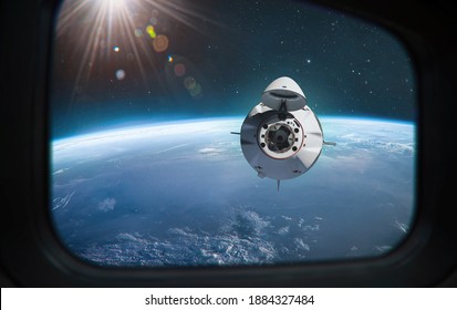 Spaceship Mission To ISS Station. View From Porthole. Space Station And Docking Of Spacecraft. Expidition From Earth. Elements Of This Image Furnished By NASA