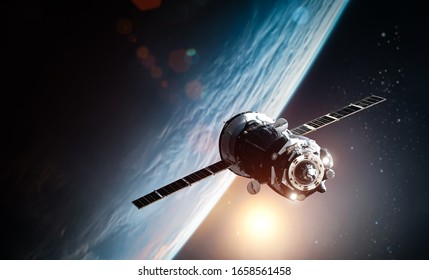Spaceship in outer space near orbit of the Earth planet. Sun and stars on the background. Elements of this image furnished by NASA - Shutterstock ID 1658561458