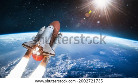 Spaceship in the outer space on orbit of Earth planet. Space shuttle in sky with clouds. Continents and oceans. Elements of this image furnished by NASA
