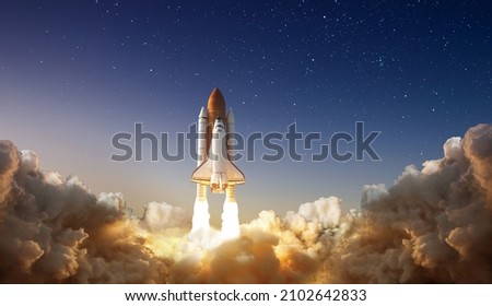 Spaceship takes off into the night sky on a mission. Rocket starts into space concept.Elements of this image furnished by NASA
