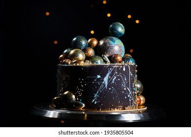 Space-themed cake. Cake decorated with planets and stars on a dark background. NASA cake.