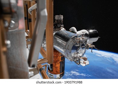 SpaceX Crew Dragon spacecraft is docked to the Space Station. Elements of this image furnished by NASA.