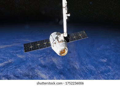 SpaceX Crew Dragon spacecraft docking to the International Space Station. Dragon is capable of carrying up to 7 passengers to and from Earth orbit, and beyond. Elements of this image furnished by NASA