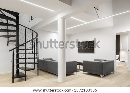Spacious apartment in white with spiral stairs, pillar, led ceiling lights and simple living room with tv