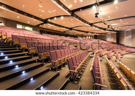 Spacious auditorium with rows of chairs and stairs