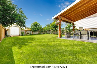 Spacious backyard with patio area.