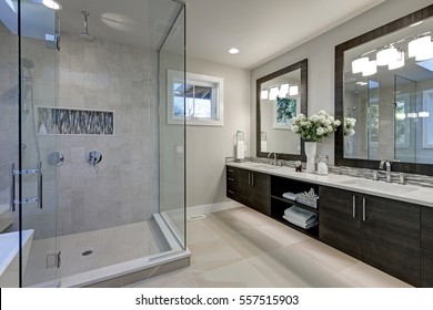 Spacious bathroom in gray tones with heated floors, walk-in shower, double sink vanity and skylights. Northwest, USA