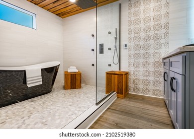 Spacious Bathroom With Tub And Shower In Enclosure Glass Walls Black Bathtub Tiger Wood Accents Decorative Tile And Mosaic Floor Tile