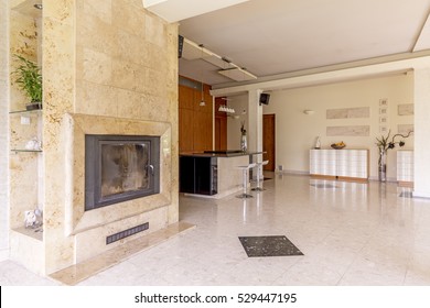 Spacious And Bright Area Of Living Room With The Marble Fireplace, Floor And View Of Open Plan Kitchen Area