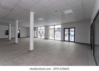 A Spacious Empty Commercial Space Featuring Large Windows That Provide Abundant Natural Light