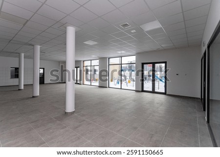 A Spacious Empty Commercial Space Featuring Large Windows That Provide Abundant Natural Light