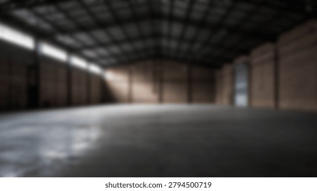 A spacious, empty industrial warehouse interior featuring a concrete floor, metal roof, and natural light streaming through the windows. The warehouse is devoid of people or objects.