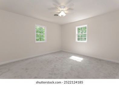 Spacious Empty Room With Two Windows And Ceiling Fan.