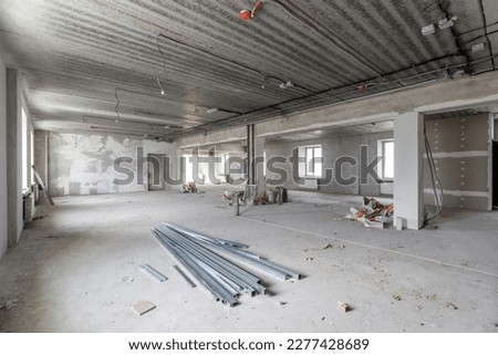 Spacious empty rooms in the attic floor after filling out the work on the wall and ceiling.