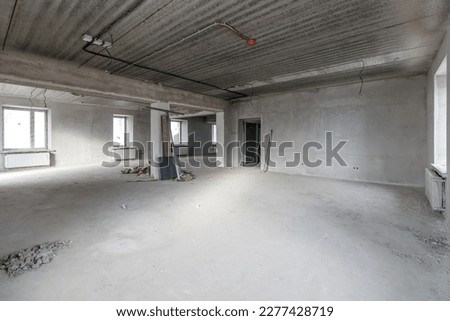 Spacious empty rooms in the attic floor after filling out the work on the wall and ceiling.