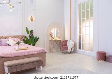 spacious expensive luxury bright interior of open-plan apartment in pink colors with dressing room, bedroom area and cozy area for guests with soft furniture. fashionable LED lighting and huge windows - Shutterstock ID 2111911577