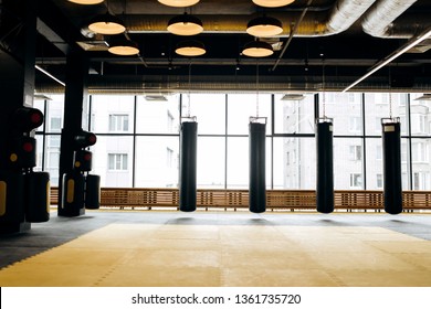 Spacious gym with panoramic windows and three punching bags