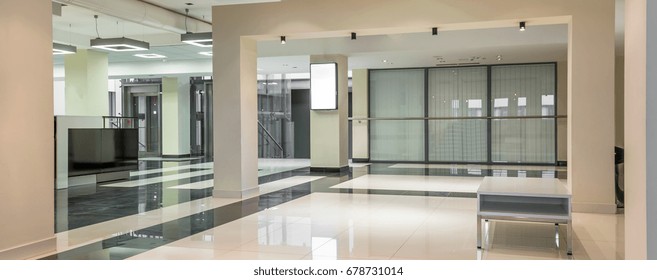 Spacious Hallway With Marble Floors At Up-to-date University. In The Middle Coffee Table