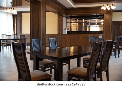 spacious interior of modern empty large restaurant with tables and chairs