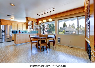 Spacious Kitchen Room With Linoleum. Round Dining Table Decorated With Flowers