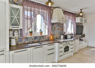 Spacious kitchen with white cabinets and colorful tiles classic contemporary style