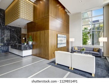 Spacious lobby area with high ceiling and wood paneling, interior of a modern luxurious condominium. Northwest, USA