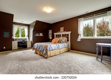 Spacious Master Bedroom Interior With Soft Carpet Floor And Dark Brown Walls. Room Has Small Office Area By The Window