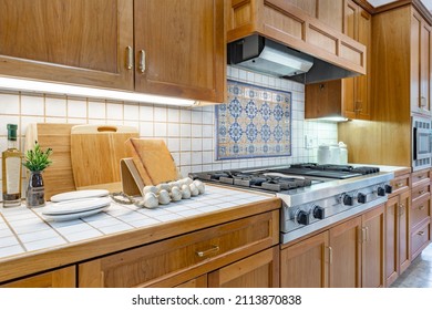 Spacious Mid Century Craftsman Home Kitchen With Tiled Countertops White Appliances Dining Areas Bar Stools In White Pine Coloured Cabinets Mosaic Backsplash