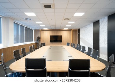 Spacious and modern conference room featuring a long wooden table, ergonomic chairs, a large wall-mounted screen, and natural lighting for professional meetings. - Powered by Shutterstock - Get 15% off with code: PIKWIZARD15